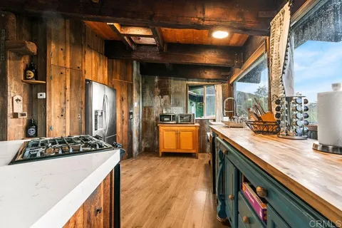 a spacious bedroom with a bed and wooden floor
