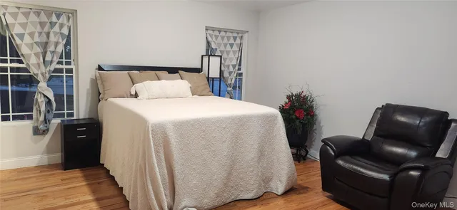 a bed room with a bed and a chair