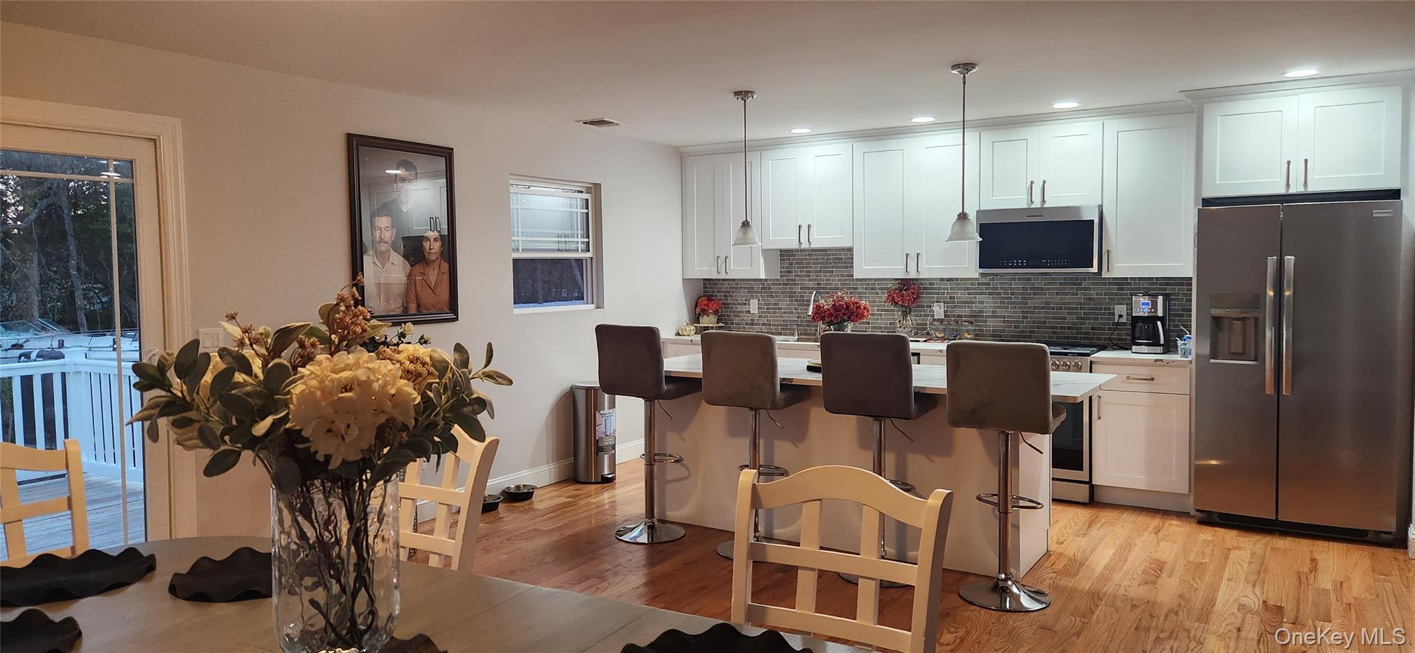 466 Granny Road Medford, NY 11763 - Photo 3 of 14 a view of a dining room with furniture and wooden floor