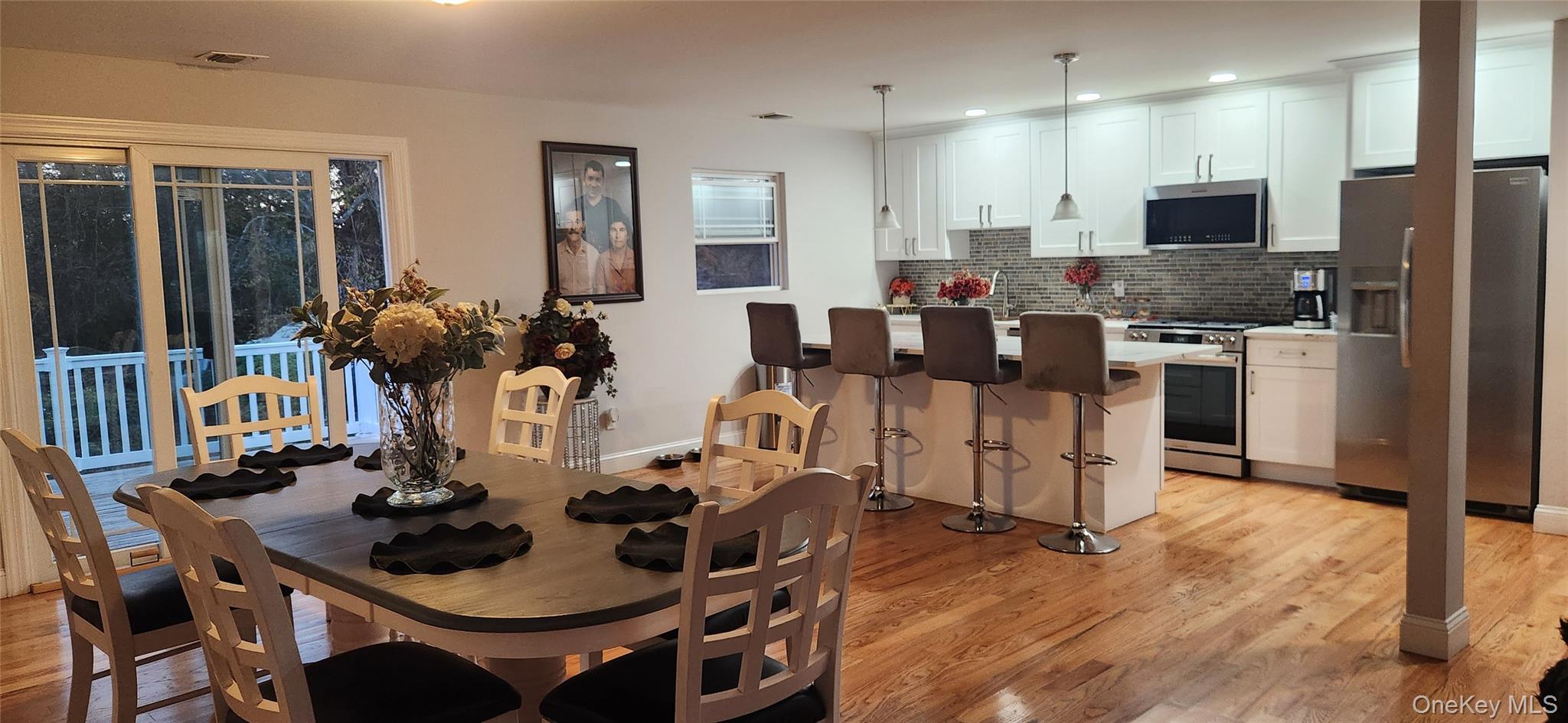 466 Granny Road Medford, NY 11763 - Photo 4 of 14 a kitchen with a dining table chairs and refrigerator