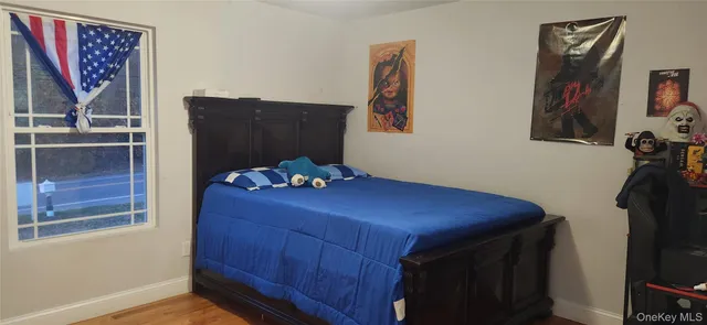 a room with painting on the wall and a potted plant