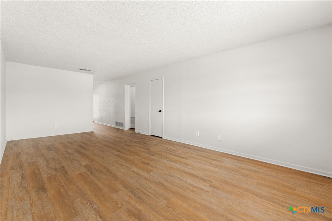 1005 Eastside Drive, Unit D Killeen, TX 76543 - Photo 3 of 9 a view of empty room with wooden floor
