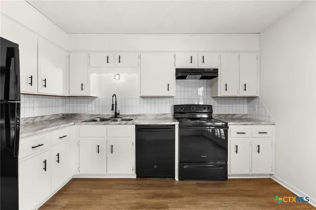 a kitchen with a refrigerator stove and sink