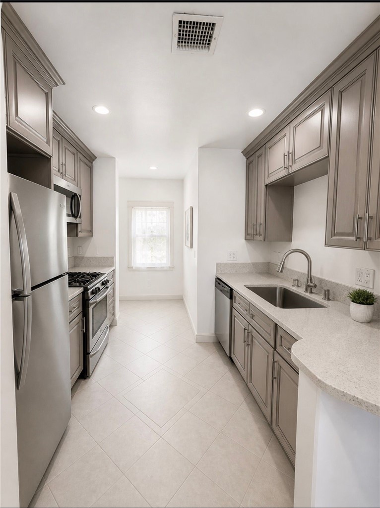 309 Alhambra Road Alhambra, CA 91801 - Photo 3 of 10 a kitchen with stainless steel appliances a sink stove and refrigerator