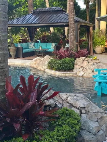 a swimming pool with outdoor seating yard and outdoor seating