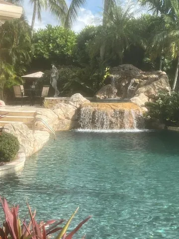 a view of a table and chairs under an umbrella in patio