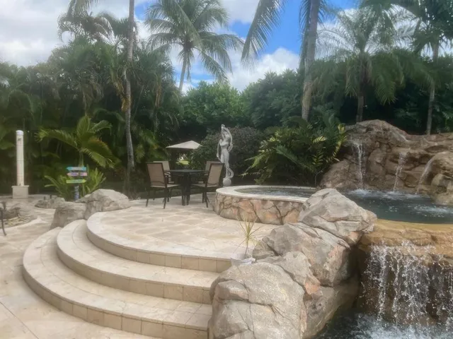a dining room with furniture and a floor to ceiling window