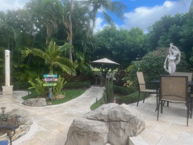 a view of backyard with plants and outdoor seating