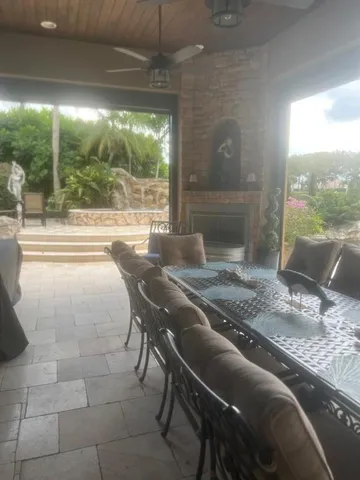 a view of a yard with potted plants and large trees