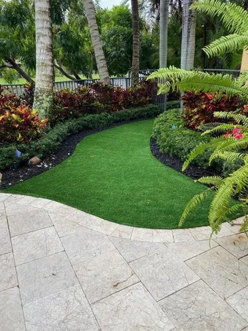 a view of a white house with a swimming pool and outdoor seating