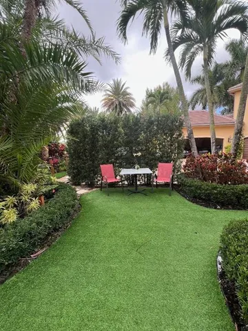 a swimming pool with outdoor seating and yard