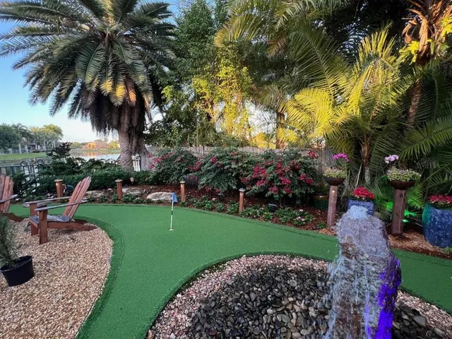 a living room with furniture a fireplace and a chandelier
