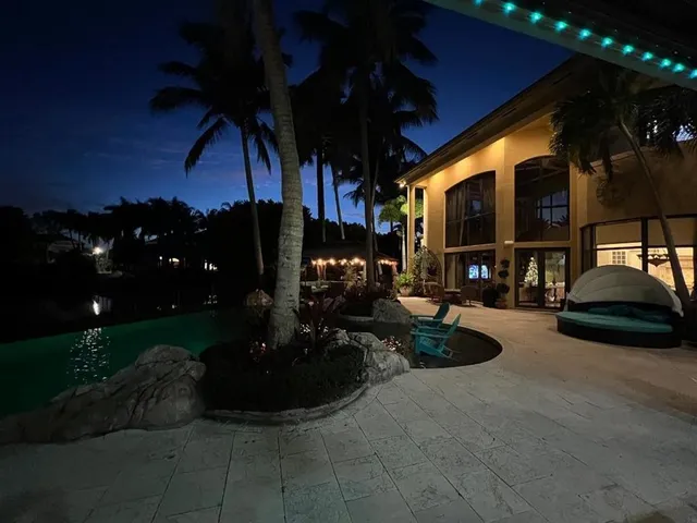 a dining room with furniture a chandelier and window