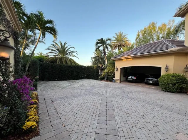 a front view of a house with a yard and a garage