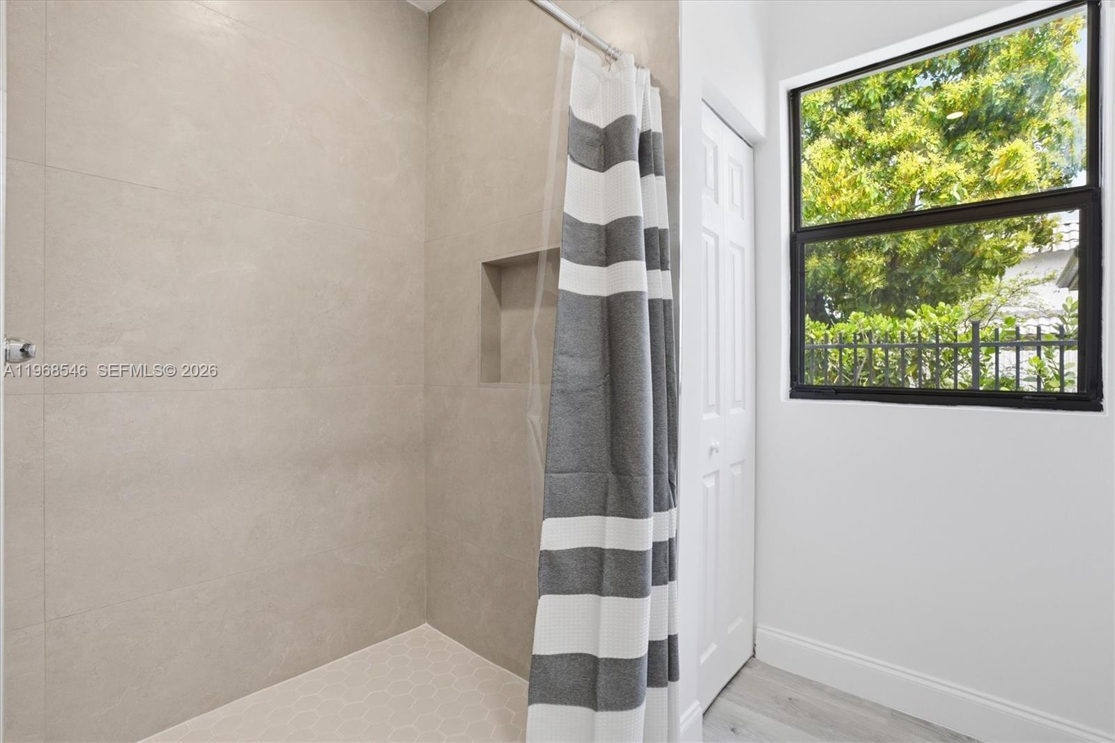 4237 Southwest 7th Street Miami, FL 33134 - Photo 15 of 31 a bathroom with a shower and a window