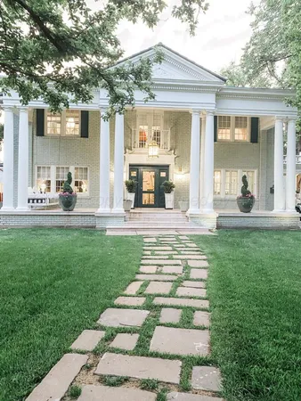 a view of a house with backyard porch and sitting area