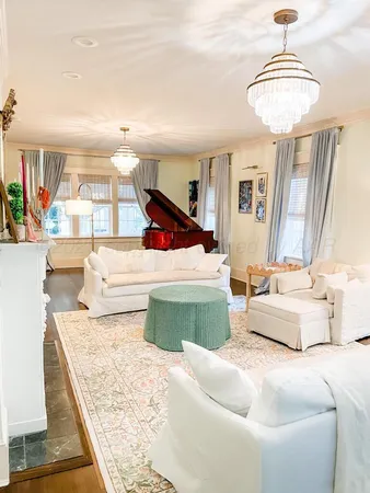 a view of staircase with white walls and white door