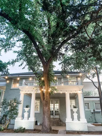 a view of a brick house with potted plants