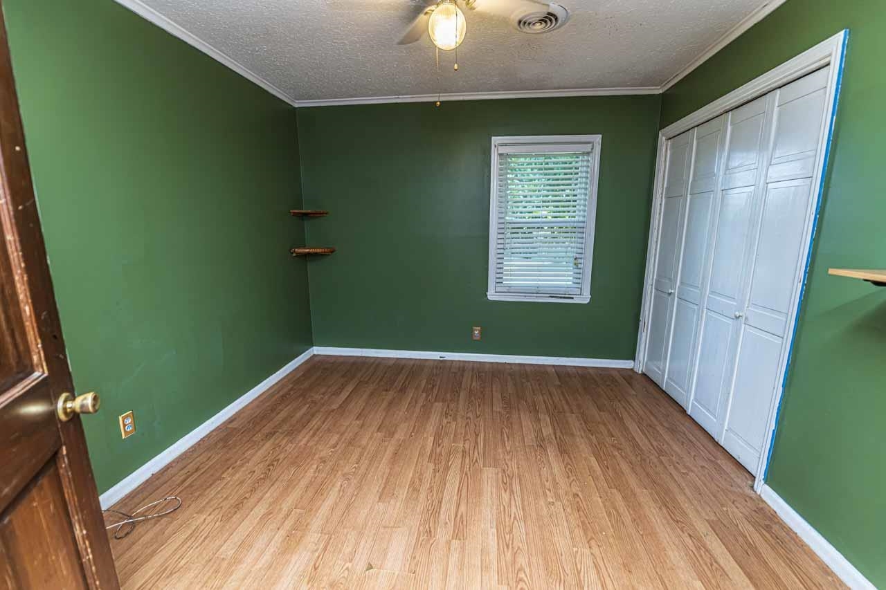 725 Old Brownsville Road Ripley, TN 38063 - Photo 23 of 40 a view of empty room with window and hardwood