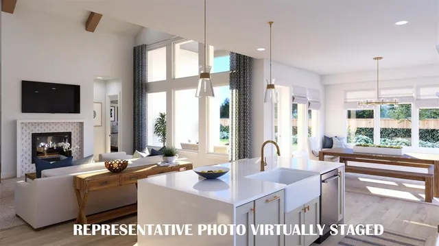 a kitchen with stainless steel appliances kitchen island granite countertop a table chairs sink and cabinets
