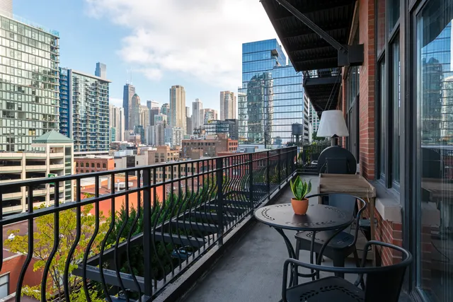 a view of a balcony with a potted plant and wooden floor