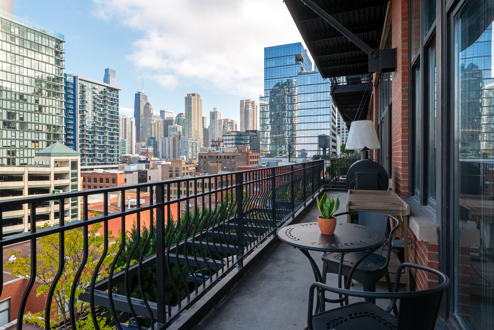 333 West Hubbard Street, Unit 801 Chicago, IL 60654 - Photo 22 of 24 a view of a balcony with a potted plant and wooden floor