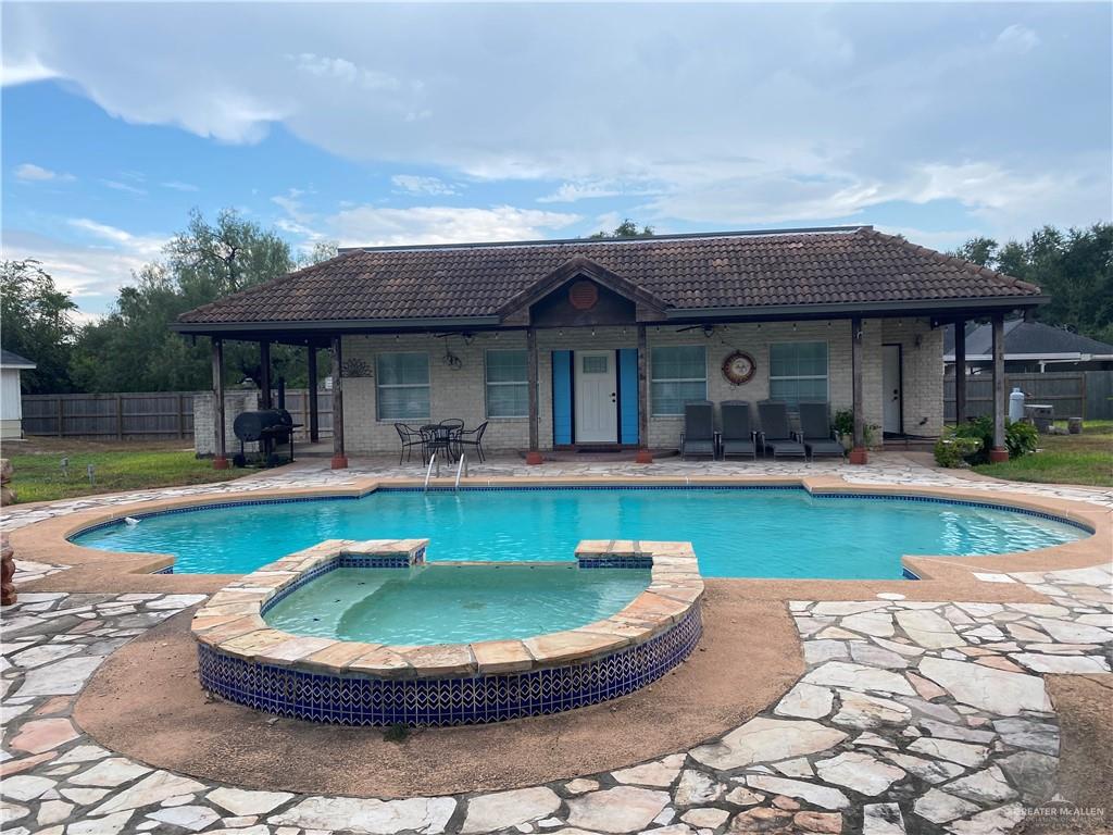 a view of a house with swimming pool and a yard