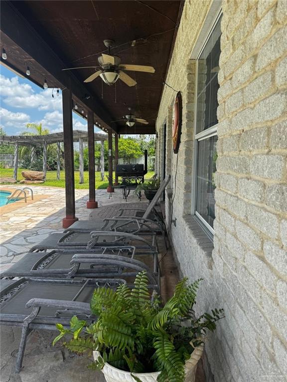 3702 North Glasscock Road Mission, TX 78573 - Photo 4 of 4 a view of a porch with furniture and floor to ceiling window