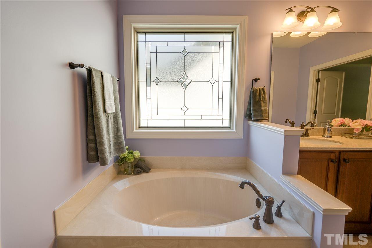 1016 Vino Drive Raleigh, NC 27607 - Photo 16 of 25 a bathroom with a tub and a window