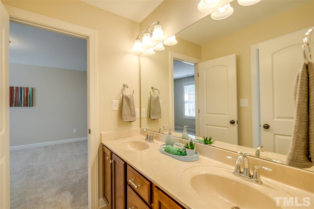 1016 Vino Drive Raleigh, NC 27607 - Photo 18 of 25 a bathroom with a double vanity sink and a mirror