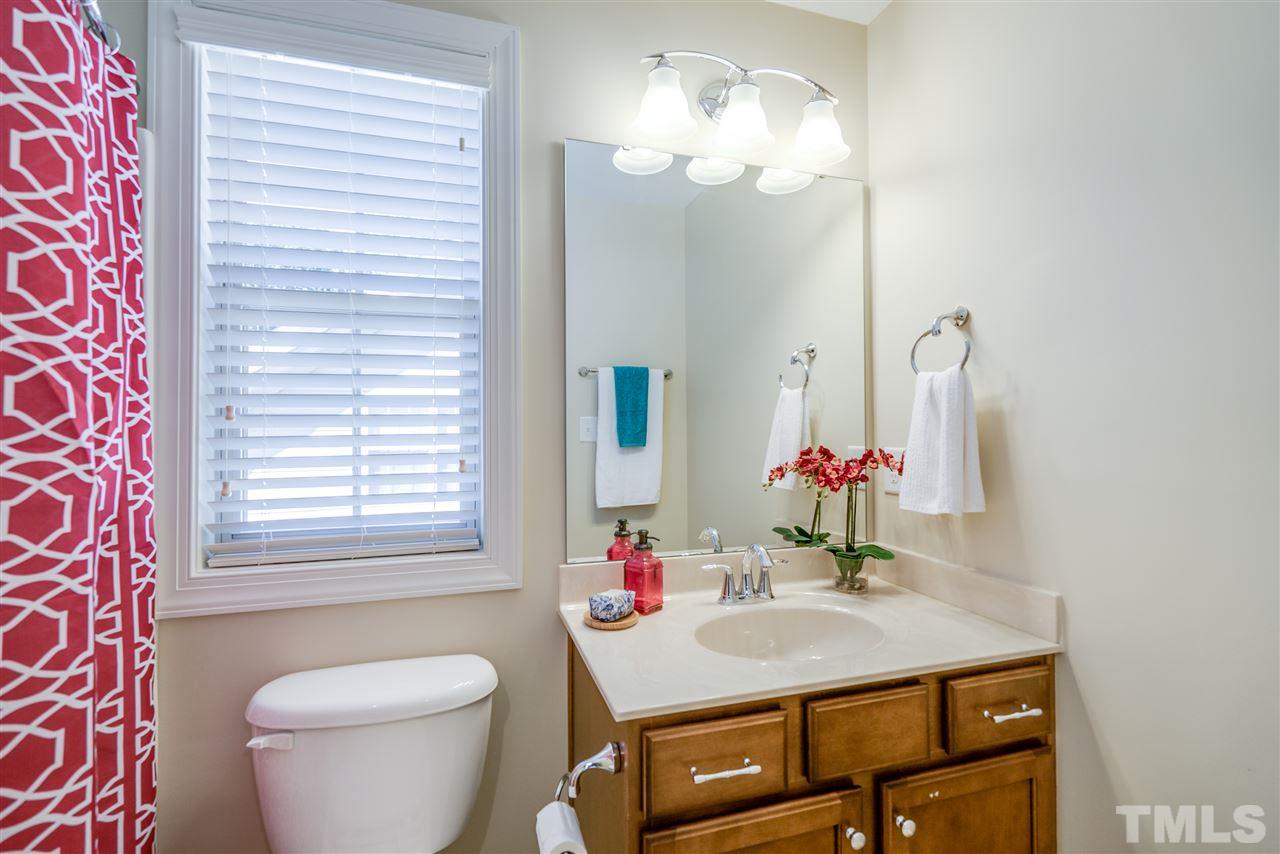 1016 Vino Drive Raleigh, NC 27607 - Photo 21 of 25 a bathroom with a sink vanity mirror and toilet