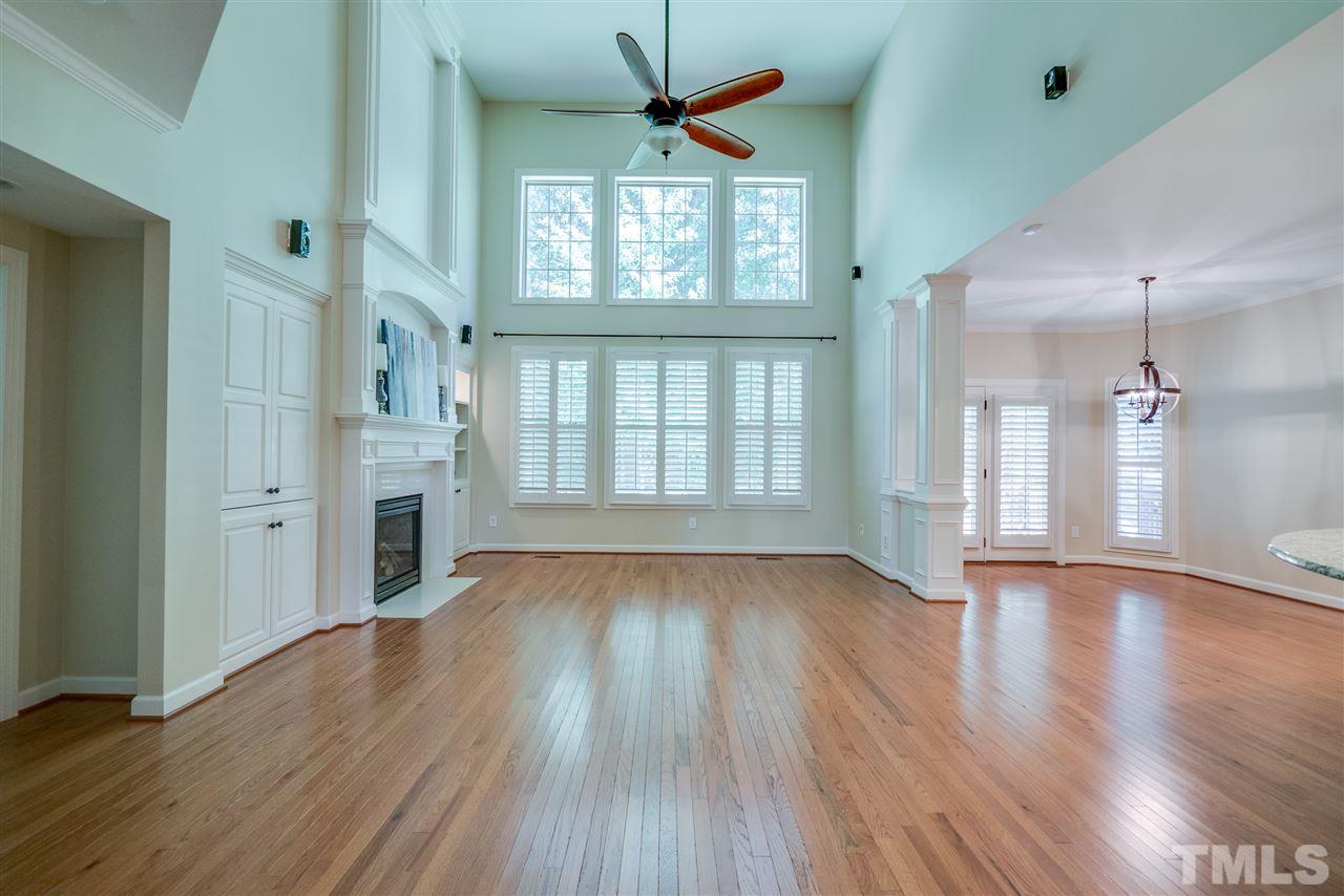 1016 Vino Drive Raleigh, NC 27607 - Photo 4 of 25 a view of an empty room with wooden floor and a window