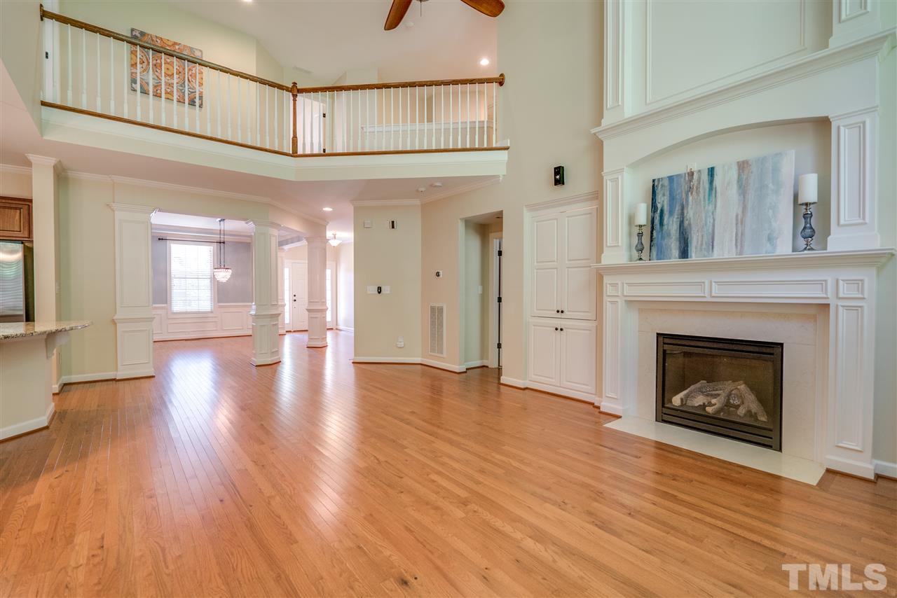 1016 Vino Drive Raleigh, NC 27607 - Photo 6 of 25 a view of a livingroom with wooden floor a fireplace