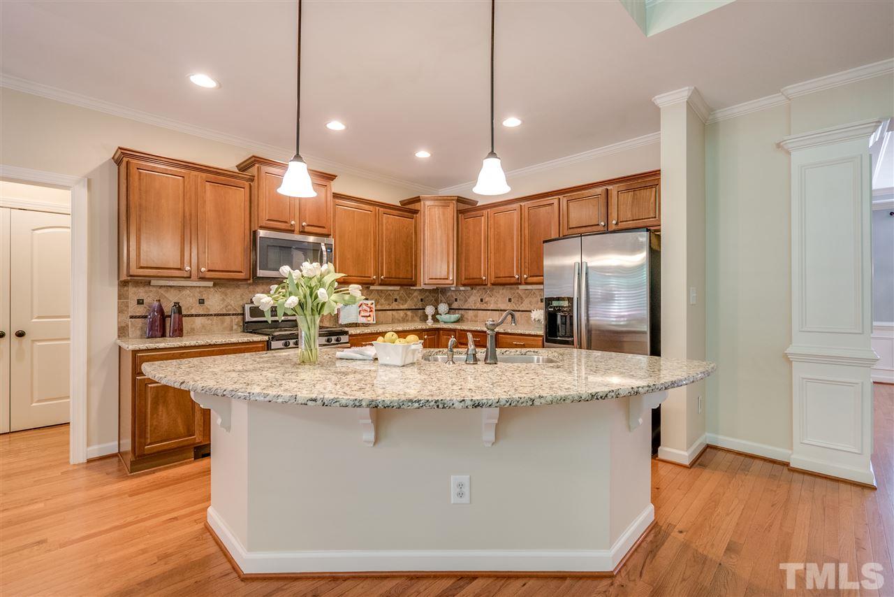 1016 Vino Drive Raleigh, NC 27607 - Photo 8 of 25 a view kitchen with a refrigerator a sink dishwasher with wooden floor and cabinets