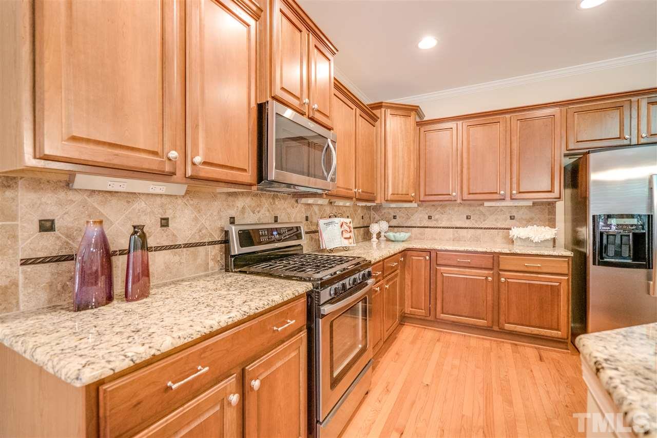 1016 Vino Drive Raleigh, NC 27607 - Photo 9 of 25 a kitchen with stainless steel appliances granite countertop a stove a sink dishwasher and a refrigerator