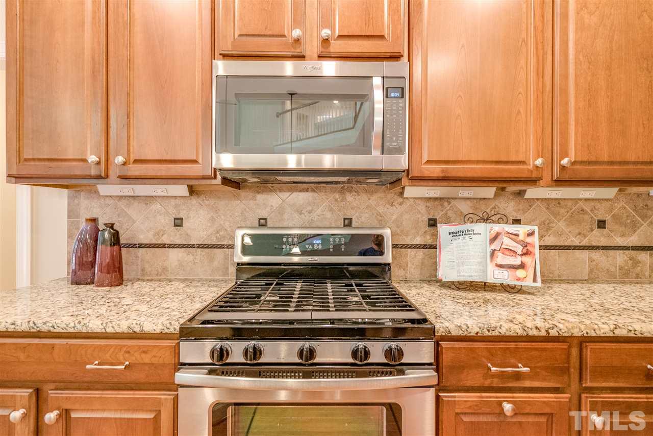 1016 Vino Drive Raleigh, NC 27607 - Photo 10 of 25 a stove top oven sitting inside of a kitchen