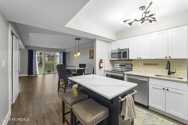a kitchen with a table chairs microwave and cabinets