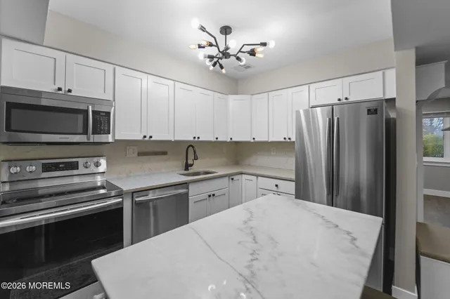 a kitchen with a refrigerator stove and microwave
