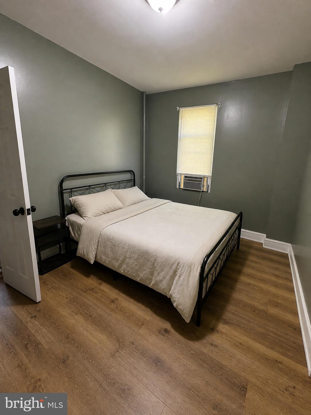 1402 Poplar Grove Street Baltimore, MD 21216 - Photo 1 of 5 a bedroom with a bed and window