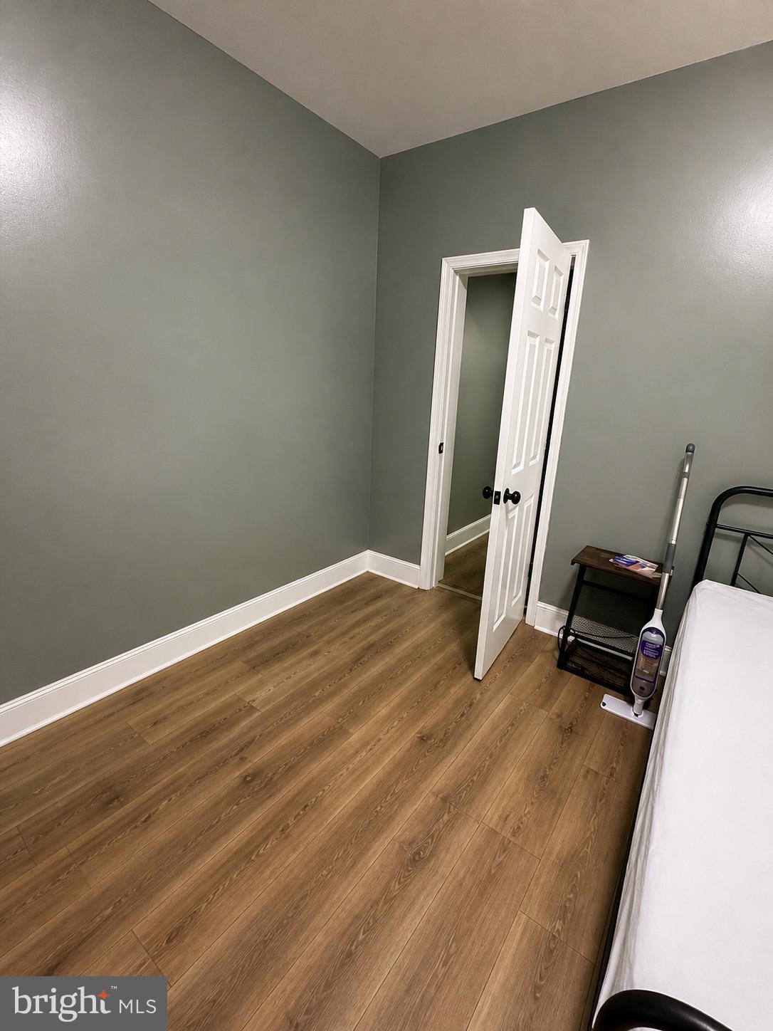1402 Poplar Grove Street Baltimore, MD 21216 - Photo 2 of 5 a view of a room with wooden floor and chair