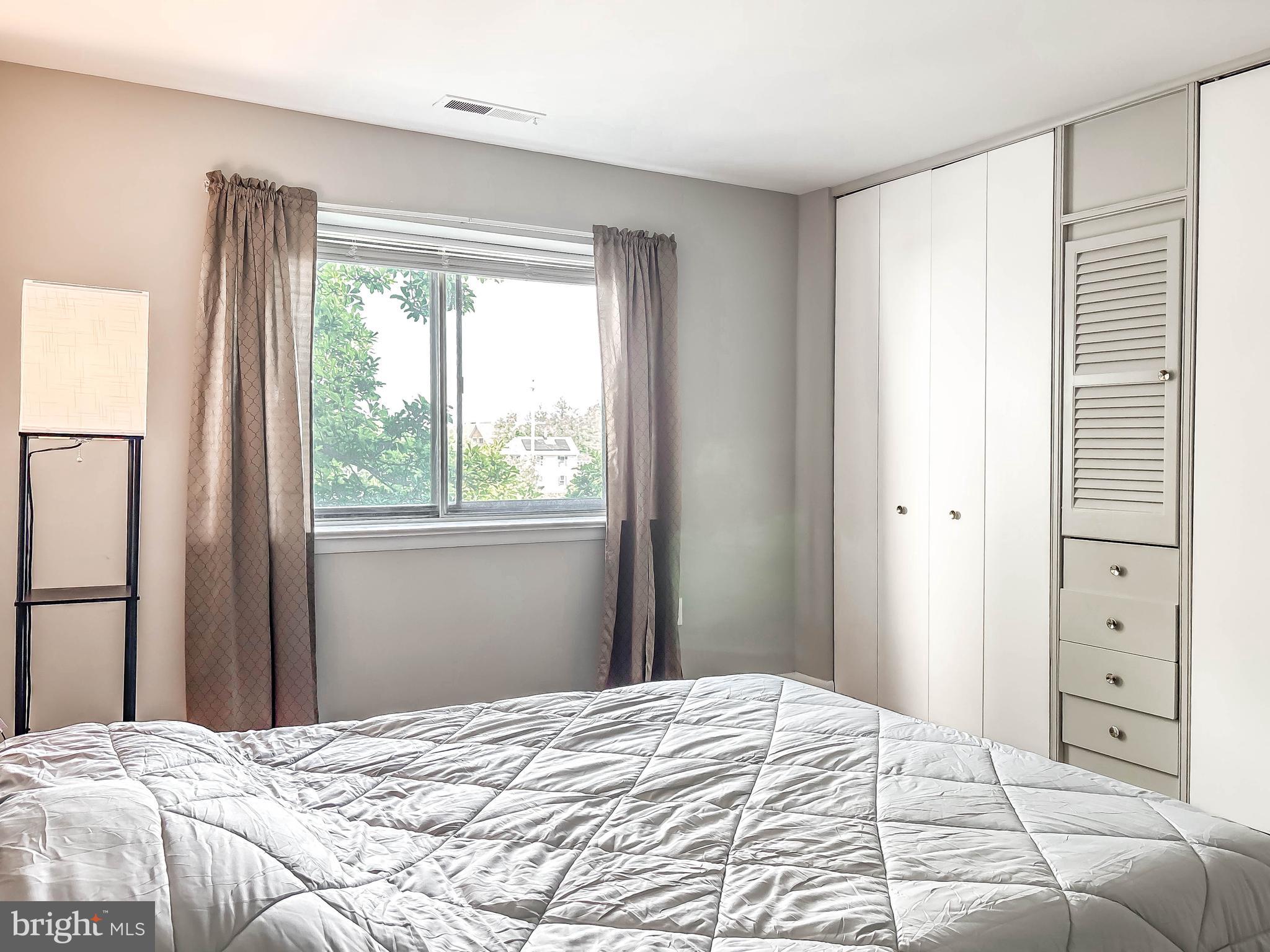 130 Slade Avenue, Unit 414 Baltimore, MD 21208 - Photo 15 of 48 a bedroom with a bed and a window