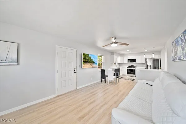 a living room with furniture and a chandelier