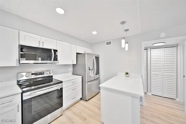 a kitchen with a refrigerator stove and microwave