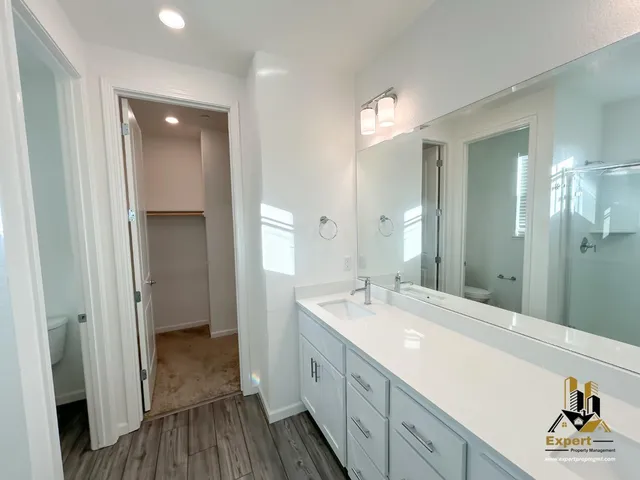 a spacious bathroom with a double vanity sink and a mirror