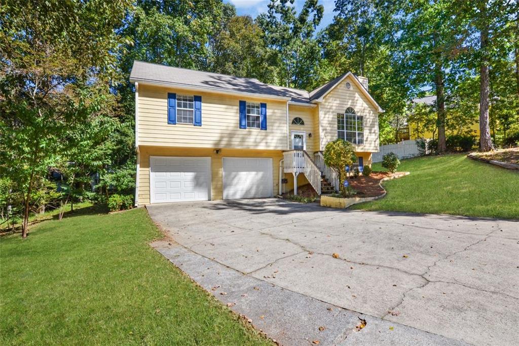 3890 Nowlin Road Kennesaw, GA 30144 - Photo 1 of 1 a view of a white house with a large space and a yard
