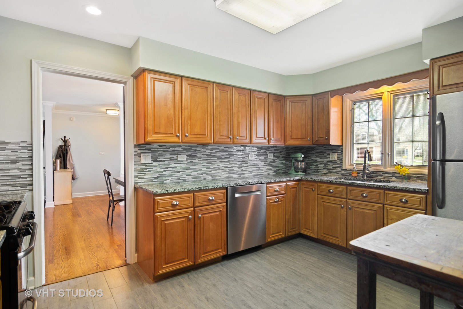 1 Applejack Road Rolling Meadows, IL 60008 - Photo 7 of 22 a kitchen with stainless steel appliances granite countertop wooden cabinets a sink and a large window