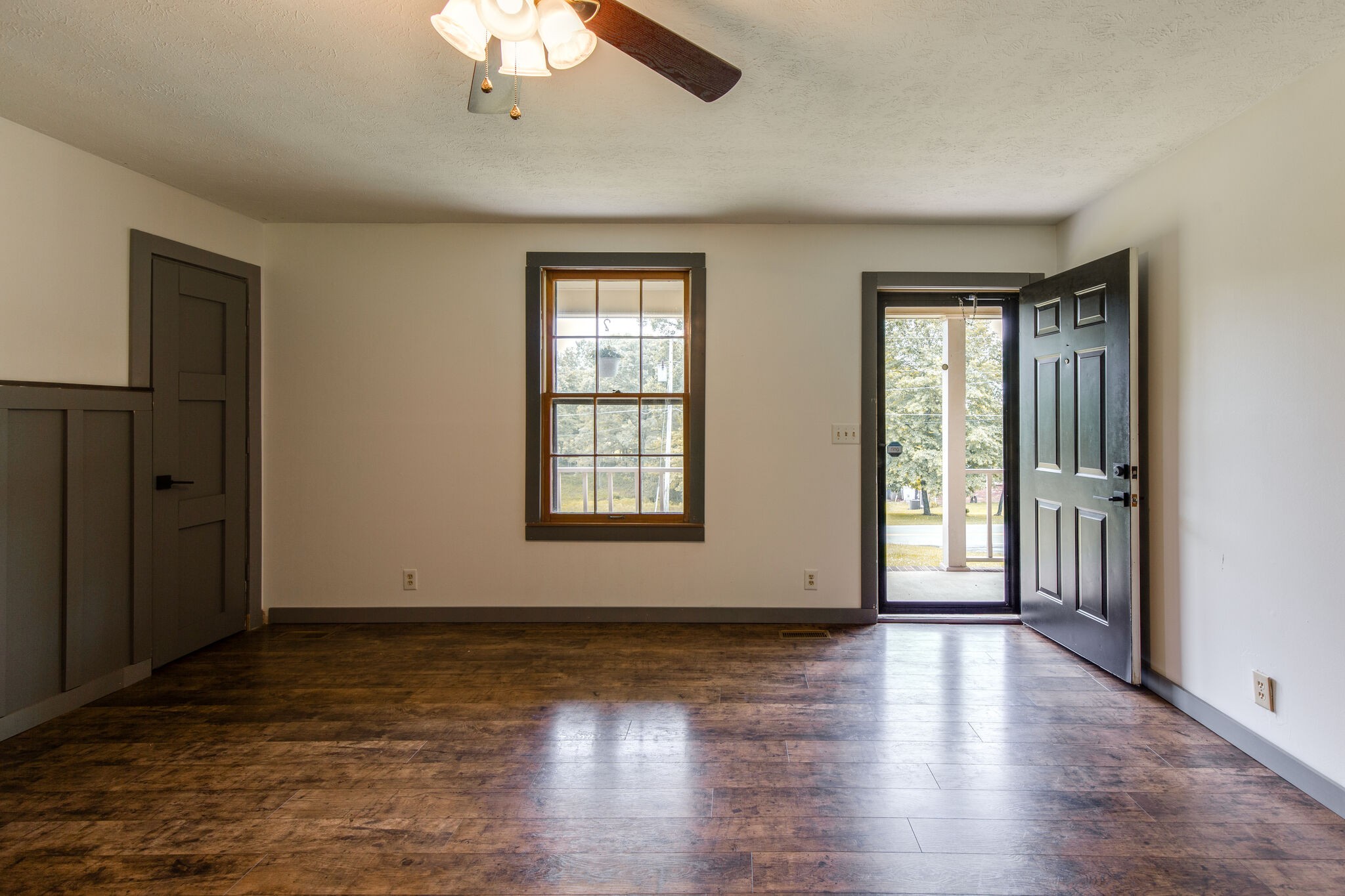1022 Garton Road Burns, TN 37029 - Photo 5 of 23 an empty room with wooden floor chandelier and windows
