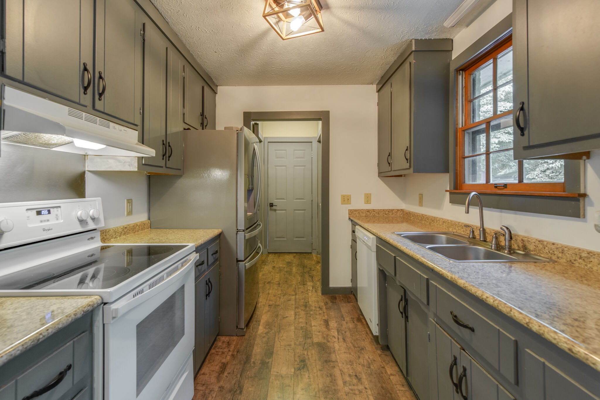 1022 Garton Road Burns, TN 37029 - Photo 9 of 23 a kitchen with a sink stove and cabinets