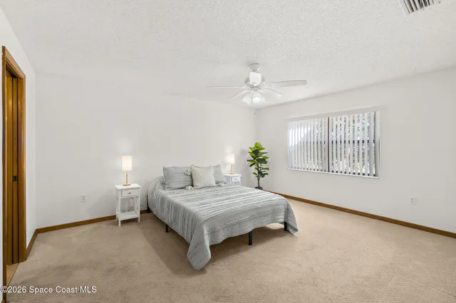 a living room with a bed furniture and a window
