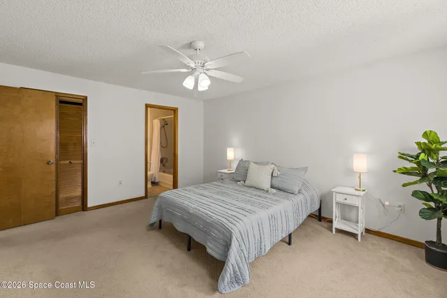 a white toilet sitting next to a bath tub and a shower